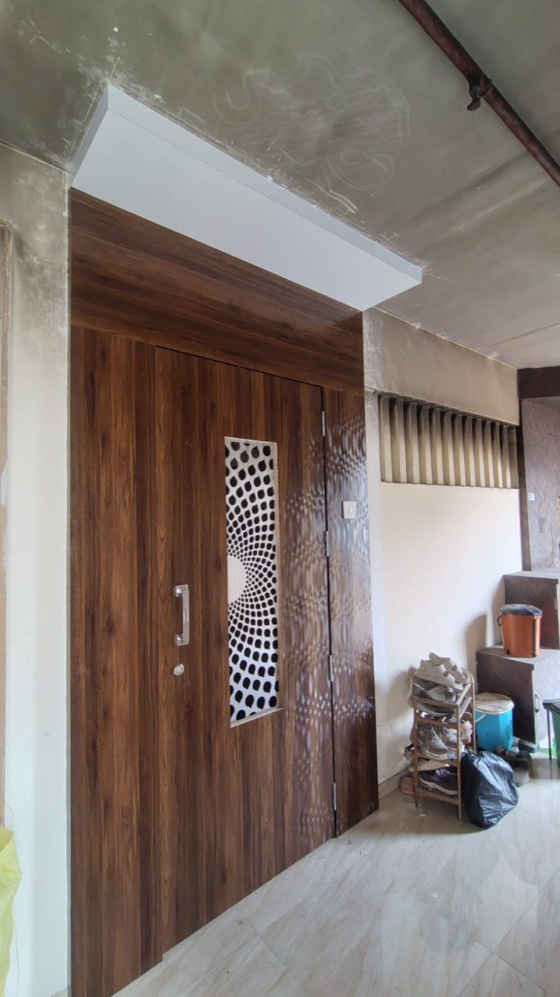 Wooden main door with a CNC-cut jali panel and matching side panel.